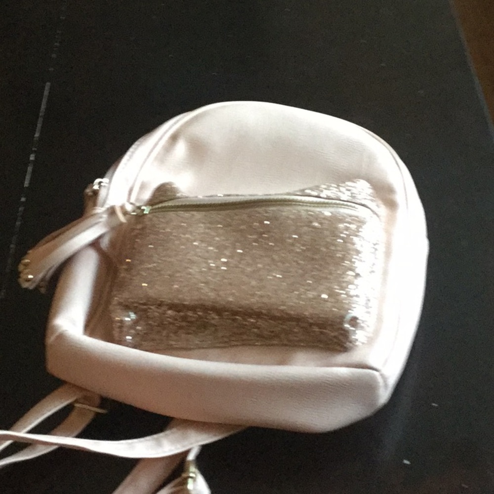 A cute pink and rose gold mini backpack